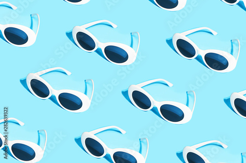 White sunglasses pattern on pastel blue background.