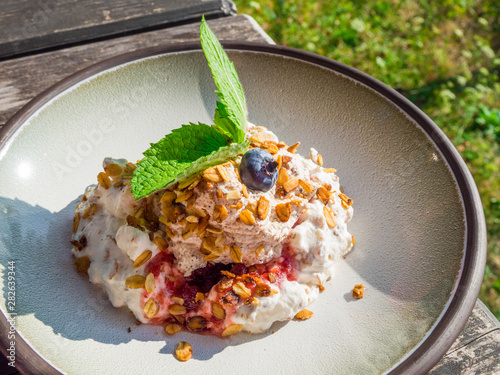 whipped cream with berry and oatmeal, delicious dessert photo