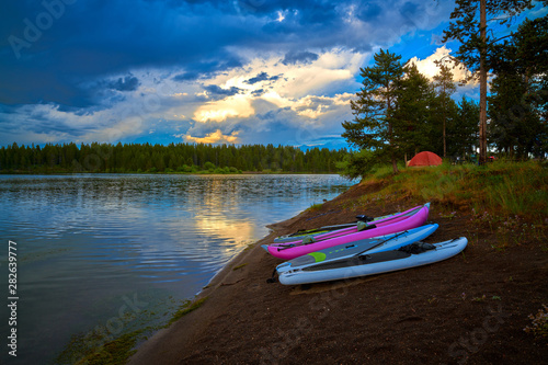 Storm clouds along Hebgen Lake with paddleboard and kayaks. photo