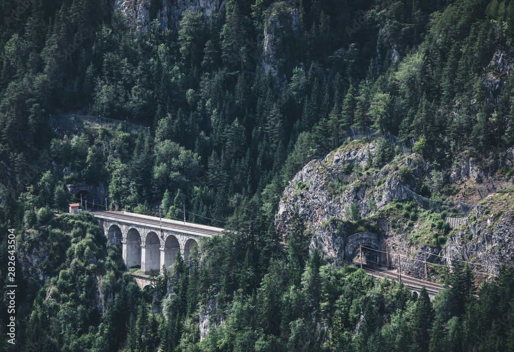 Train running on the viaduct of historic old beautiful Semmering ...