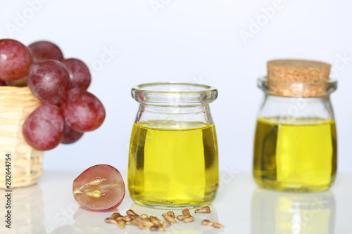 Grape seed oil in glass bottles on white background