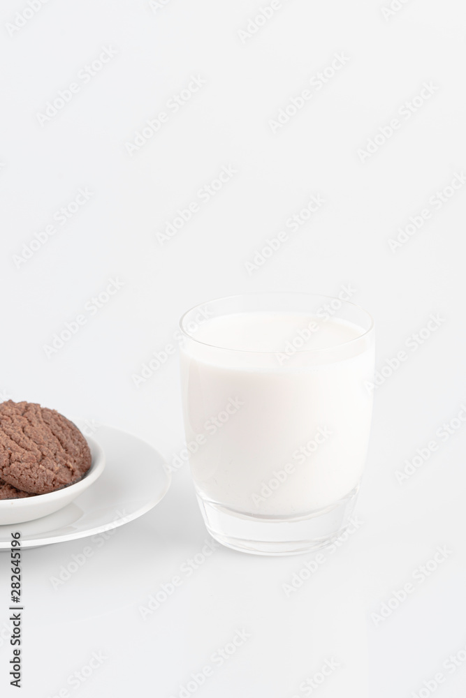 Milk glass and chocolate cookies on a white background, Milk glass and chocolate cookies on a white background,