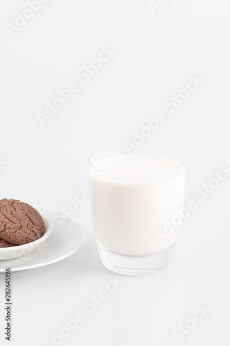 Milk glass and chocolate cookies on a white background,