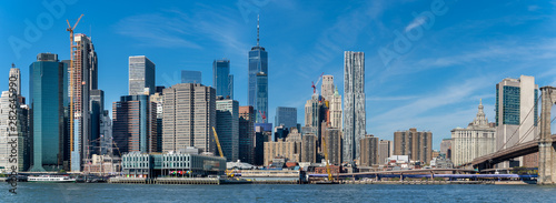 Panoramic view  of Manhattan skyscrapers and  Brooklyn bridge. © borisbelenky