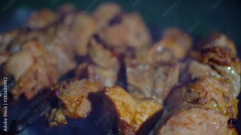 Shish kebab. Pork or lamb meat pieces being fried on a charcoal grill. Frying grilled pieces of meat during the rest. Shish kebab. Pork or lamb meat pieces being fried on a charcoal grill. Frying grilled pieces of meat during the rest.