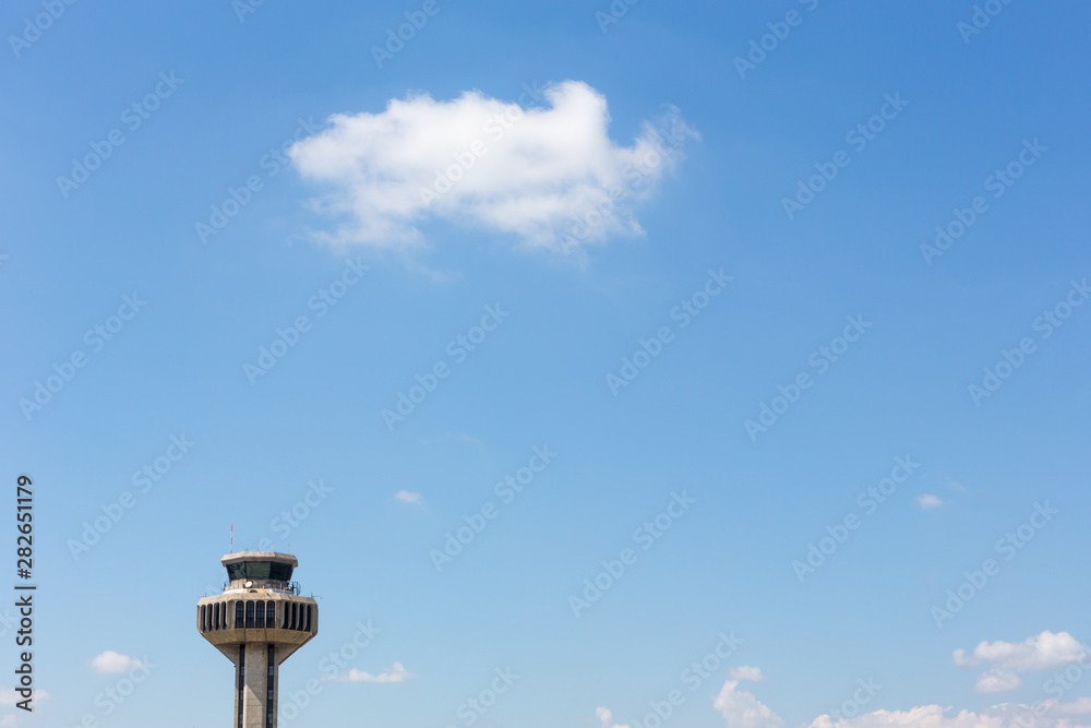 Air traffic control tower made of concrete in international airport. Blue sky and white cloud background. Travel, tourism, architecture and security concept. Space for text. Viracopos.