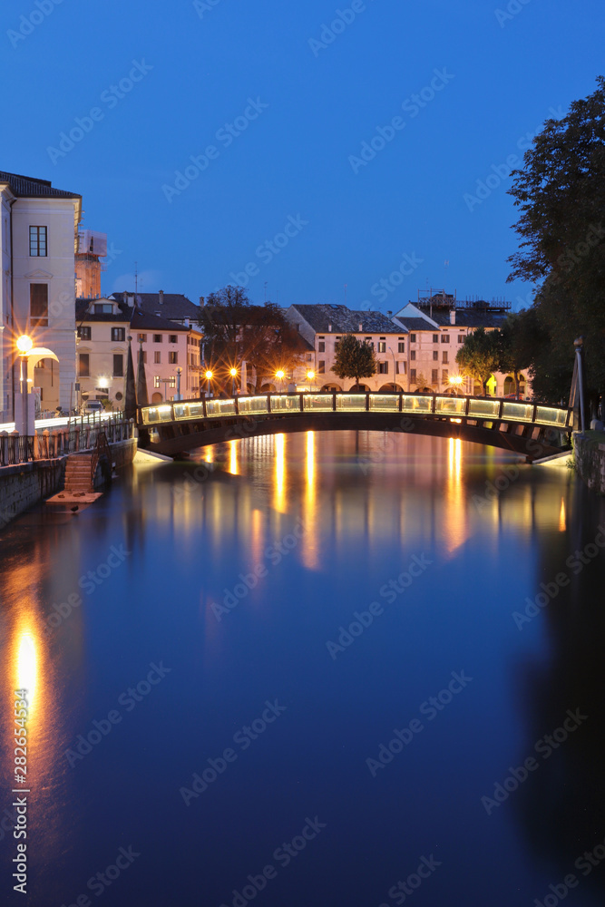treviso city with sile river and old buildings by evening