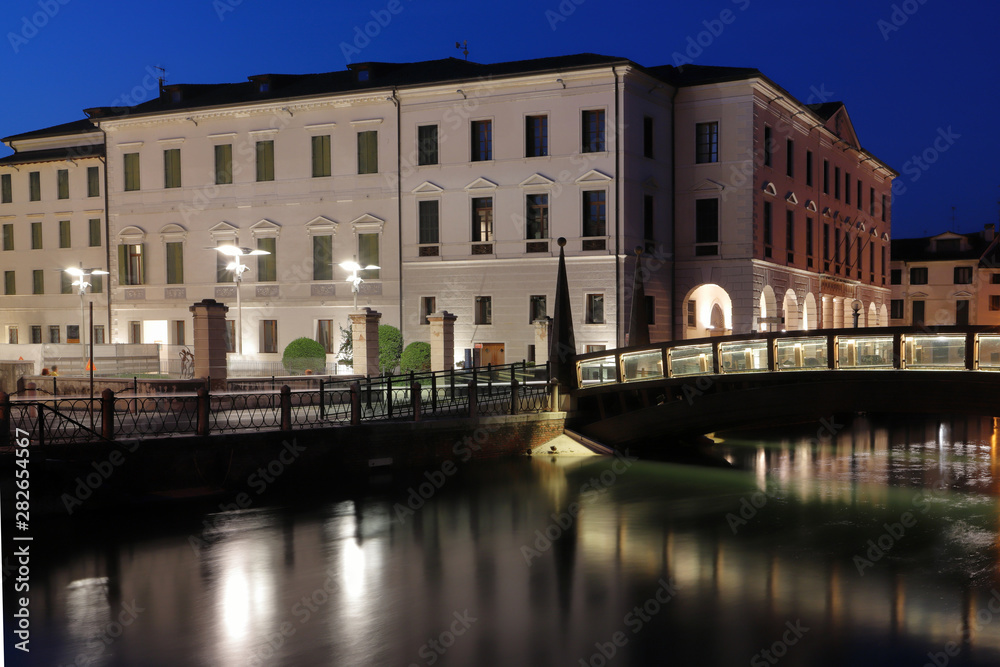 treviso city with sile river and old buildings by evening
