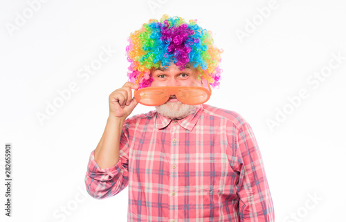 Circus show. Elderly clown. Man senior bearded cheerful person wear colorful rainbow wig. Grandpa always fun. Having fun. Funny lifestyle. Fun and entertainment. Comic happy grandfather concept