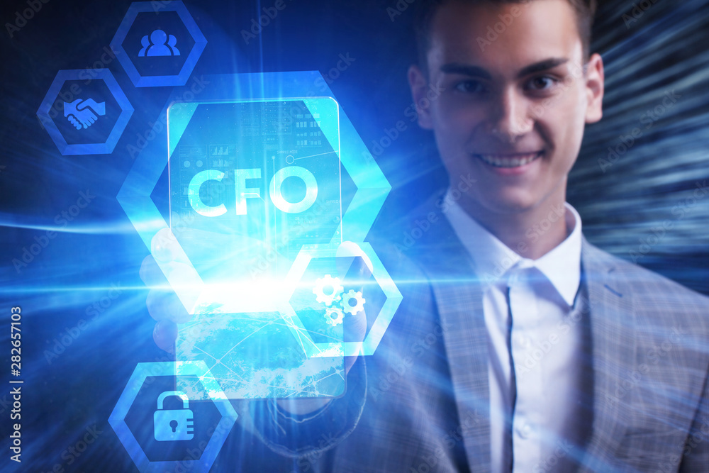 The concept of business, technology, the Internet and the network. A young entrepreneur working on a virtual screen of the future and sees the inscription: CFO The concept of business, technology, the Internet and the network. A young entrepreneur working on a virtual screen of the future and sees the inscription: CFO