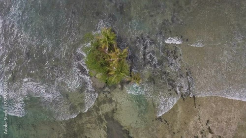 Top view of beautiful tiny island in the middle of the sea surface photo