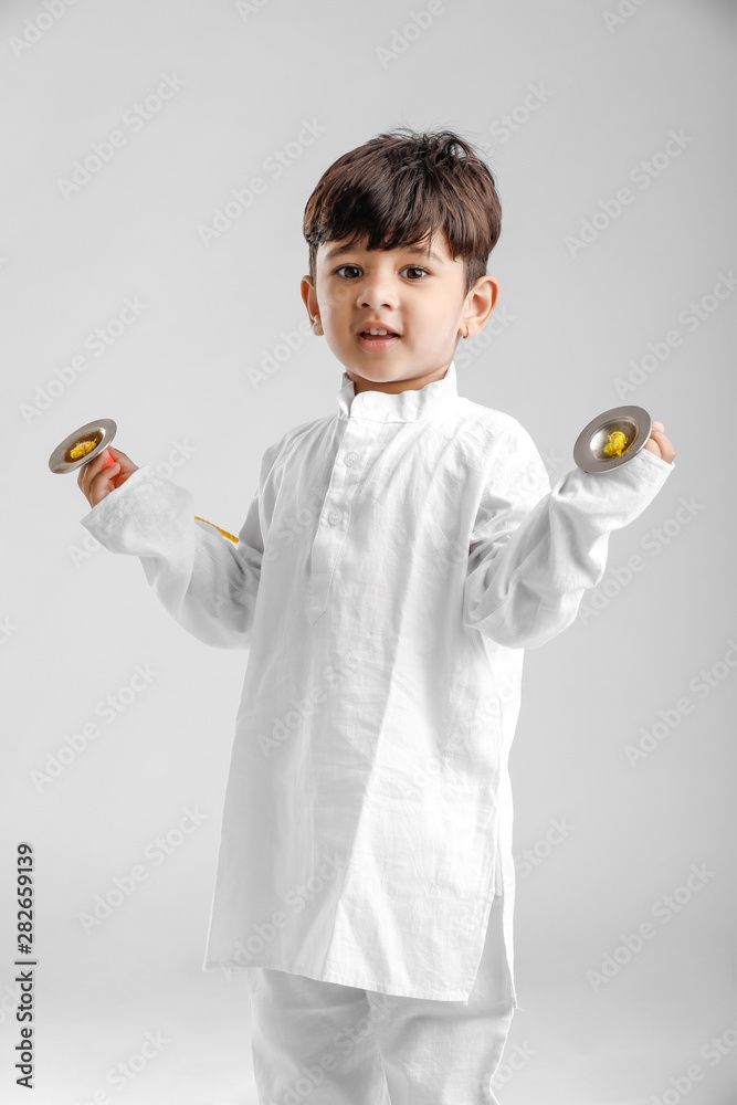 Indian Little Boy in Traditional Dress and learning with Musical instrument Indian Little Boy in Traditional Dress and learning with Musical instrument