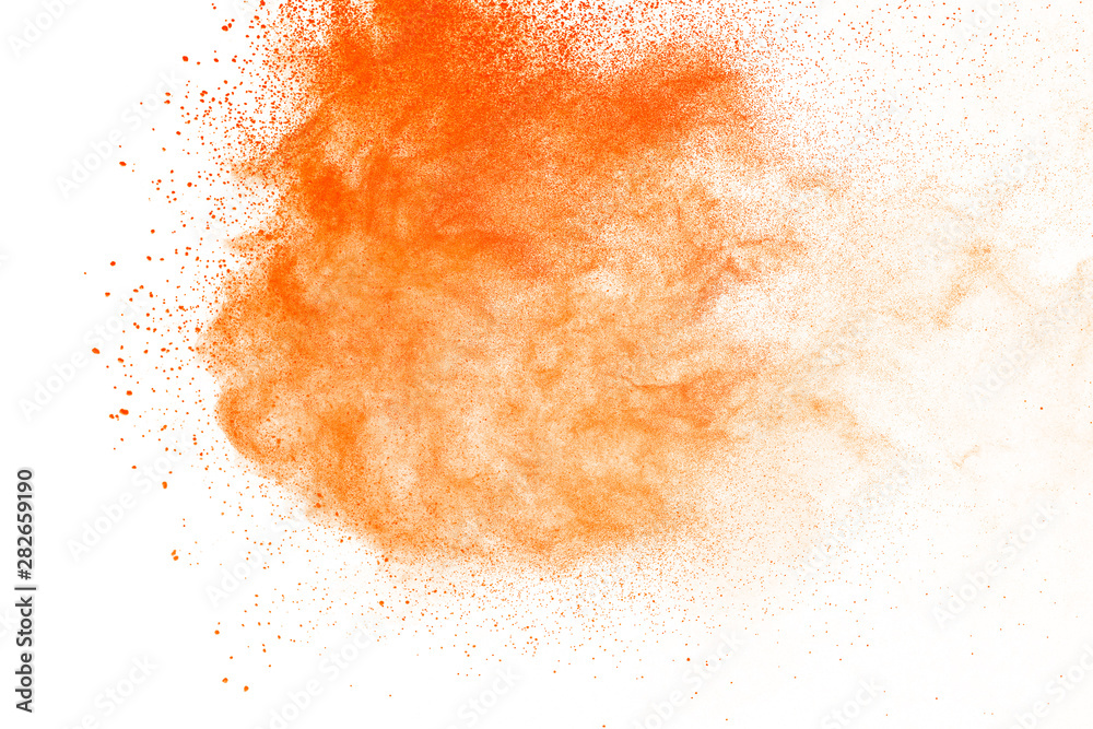 Abstract orange powder explosion. Closeup of orange dust particle splash isolated on white background
