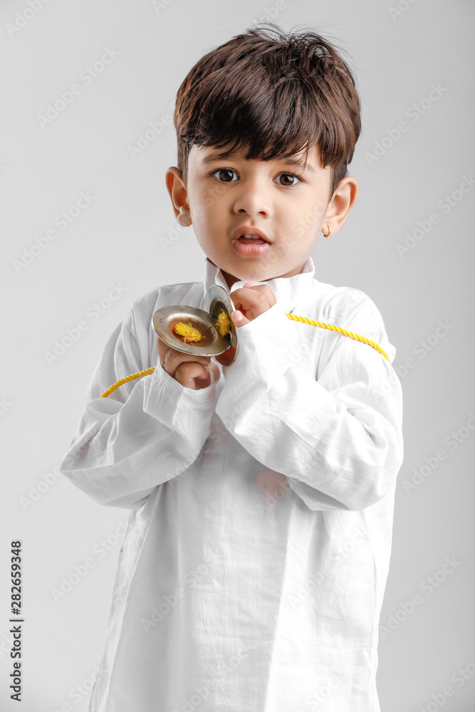 Indian Little Boy in Traditional Dress and learning with Musical instrument Indian Little Boy in Traditional Dress and learning with Musical instrument