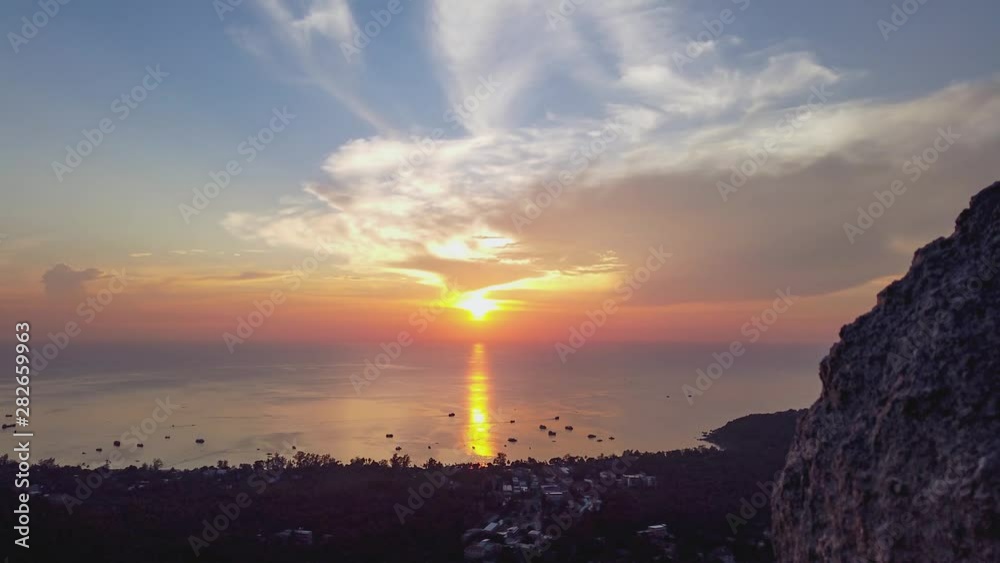 Timelapse of the sun setting over Sairee Beach, Koh Tao, Thailand; boats moving around in Sairee Bay; view from Fraggle Rock viewpoint. Timelapse of the sun setting over Sairee Beach, Koh Tao, Thailand; boats moving around in Sairee Bay; view from Fraggle Rock viewpoint.