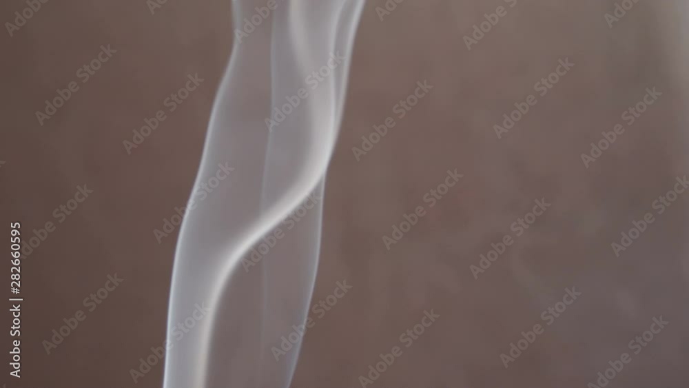 Natural curly blurred smoke waves on dark background. Transparent light slow motion close up view. White smoke from cigarette or aromatic stick or aromastick Natural curly blurred smoke waves on dark background. Transparent light slow motion close up view. White smoke from cigarette or aromatic stick or aromastick