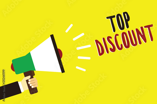Text sign showing Top Discount. Conceptual photo Best Price Guaranteed Hot Items Crazy Sale Promotions Man holding megaphone loudspeaker yellow background message speaking loud © Artur