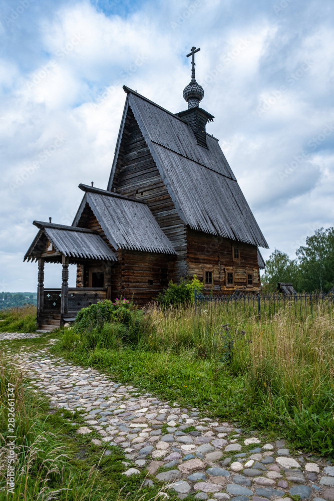 Wooden Resurrection Church in Plyos on a cloudy summer day.