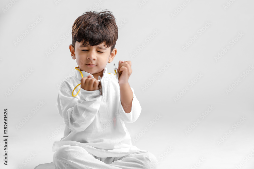 Indian Little Boy in Traditional Dress and learning with Musical instrument Indian Little Boy in Traditional Dress and learning with Musical instrument