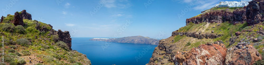 Santorini bay with white buildings of Imerovigli, on a red cliff, with the view to the village of Oia. Santorini bay with white buildings of Imerovigli, on a red cliff, with the view to the village of Oia.