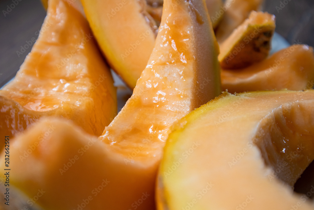 Slices of melon on wooden table Slices of melon on wooden table
