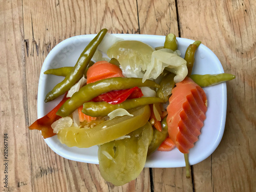 Turkish Pickles Pickled Green Pepper, Carrot and Cucumber in Bowl. photo