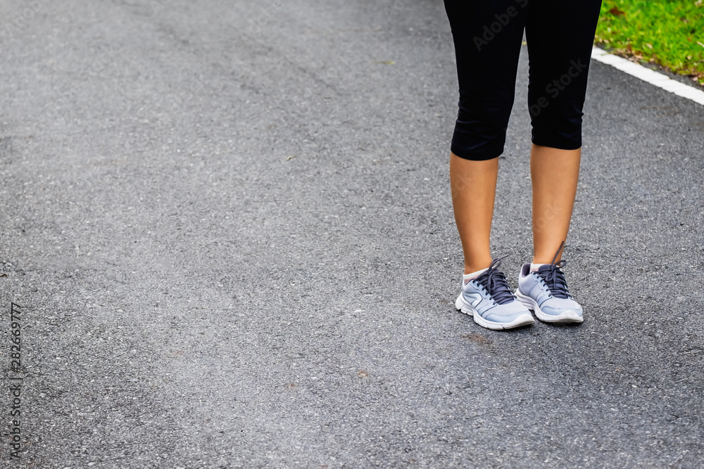 woman's leg in sport shoe on the road woman's leg in sport shoe on the road