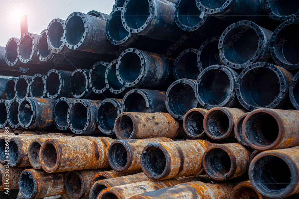 Drill pipe of oil drilling platforms. Stack of oil well casing bundles at the pin end of casing. Downhole drilling rig Drill pipe of oil drilling platforms. Stack of oil well casing bundles at the pin end of casing. Downhole drilling rig