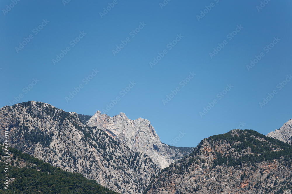 Beautiful landscape in the mountain view. Beautiful view of the Taurus mountains in the morning sun against the blue sky. Kemer, Turkey.