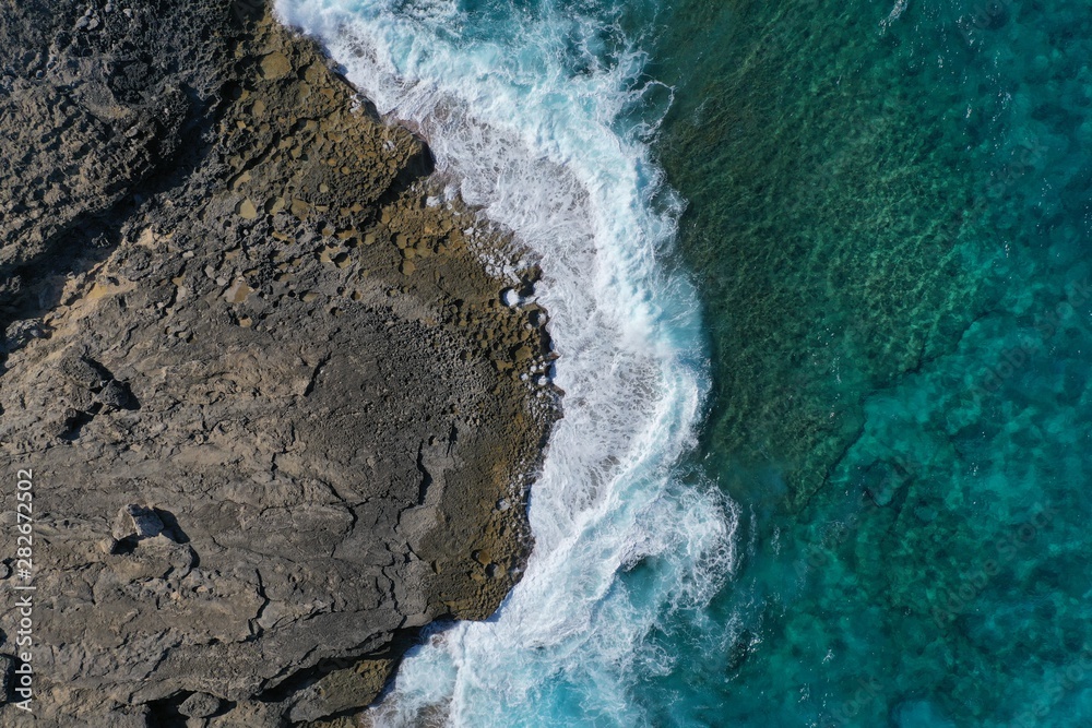 Aerial view to ocean waves and coast