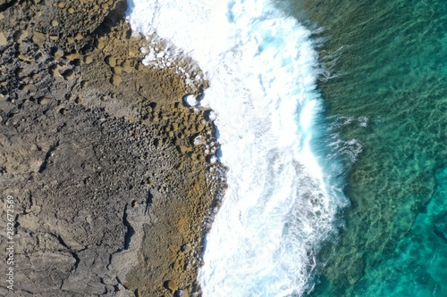 Aerial view to ocean waves and coast