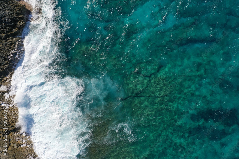 Aerial view to ocean waves and coast