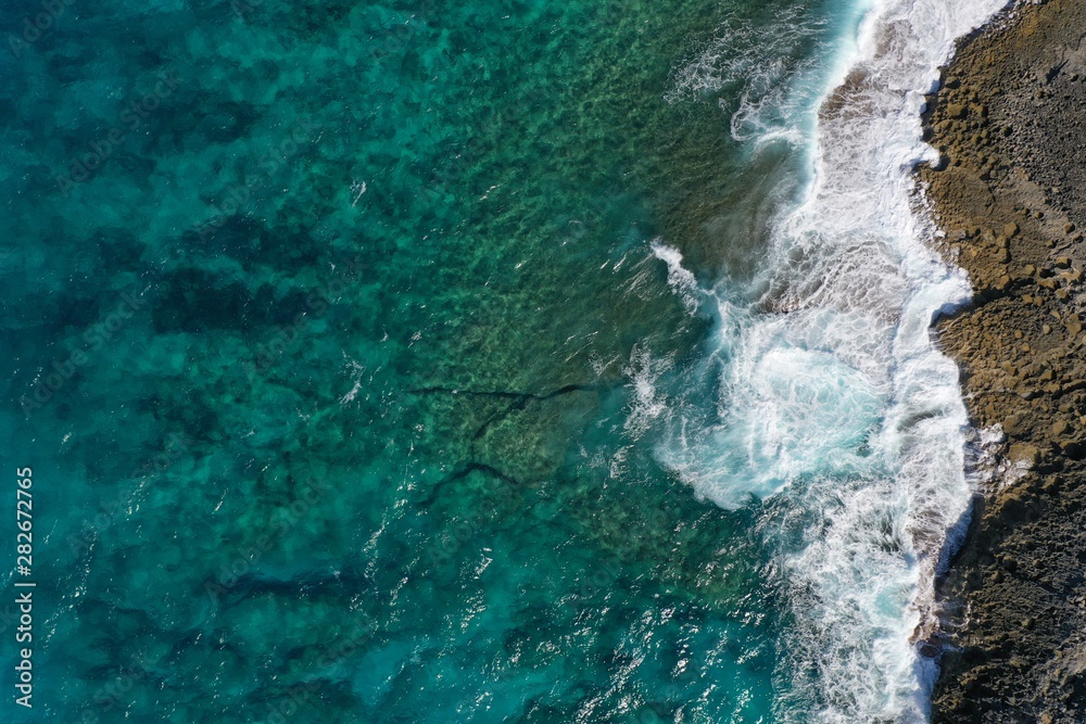 Aerial view to ocean waves and coast