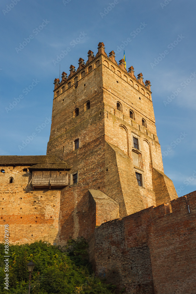 The medieval castle is illuminated by the sunset. Lutsk High Castle, also known as Lubart's Castle	