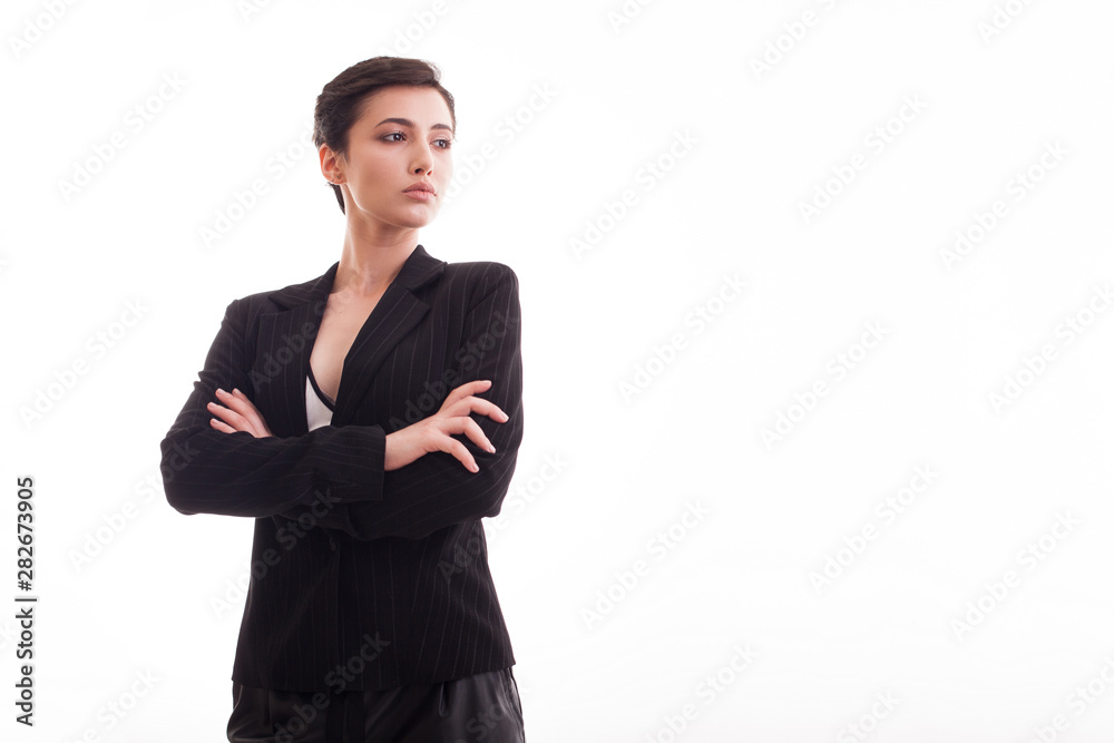 Beautiful young girl in black jacket with hands crossed looking away over white background Beautiful young girl in black jacket with hands crossed looking away over white background