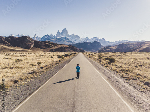 Person on the road with mountains on the background at El Chaltén, Argentina