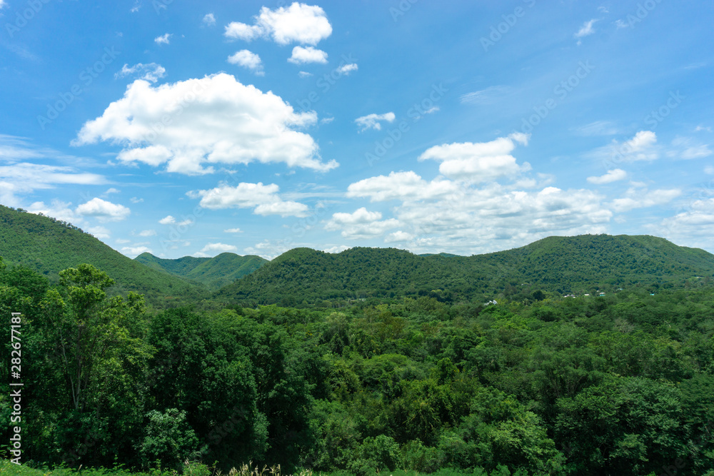 Beautiful sky And Green mountain landscape, with mountain peaks covered with forest and a cloudy sky.