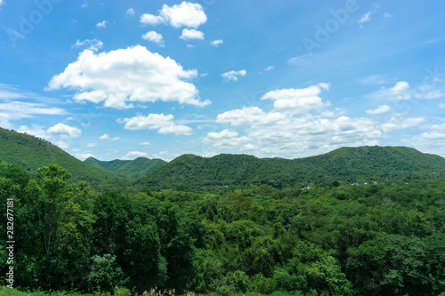 Beautiful sky And Green mountain landscape, with mountain peaks covered with forest and a cloudy sky.