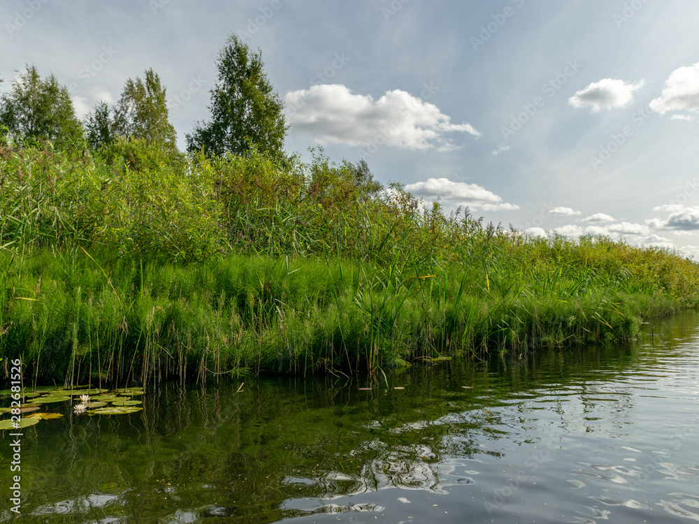 Landscape with Seda River, which flows into Burtnieki Lake. Beautiful sunny summer day, Latvia Landscape with Seda River, which flows into Burtnieki Lake. Beautiful sunny summer day, Latvia