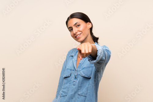 Young woman over isolated background points finger at you with a confident expression