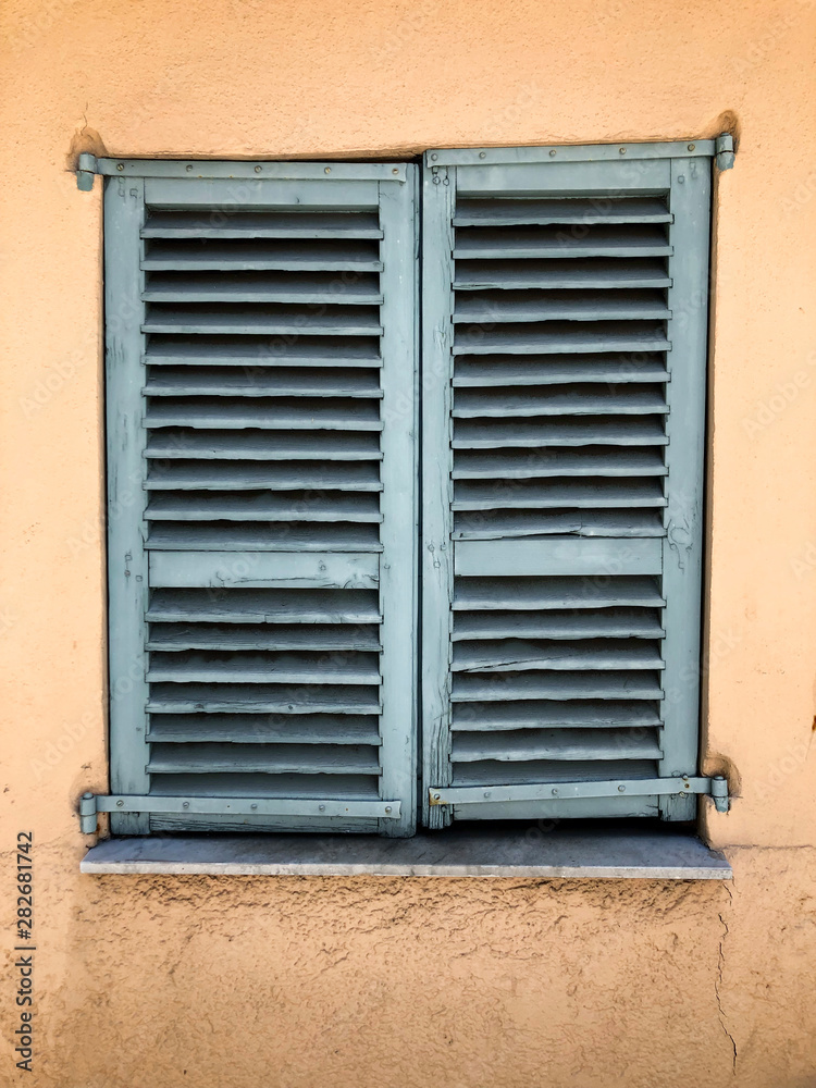 old window with closed shutters