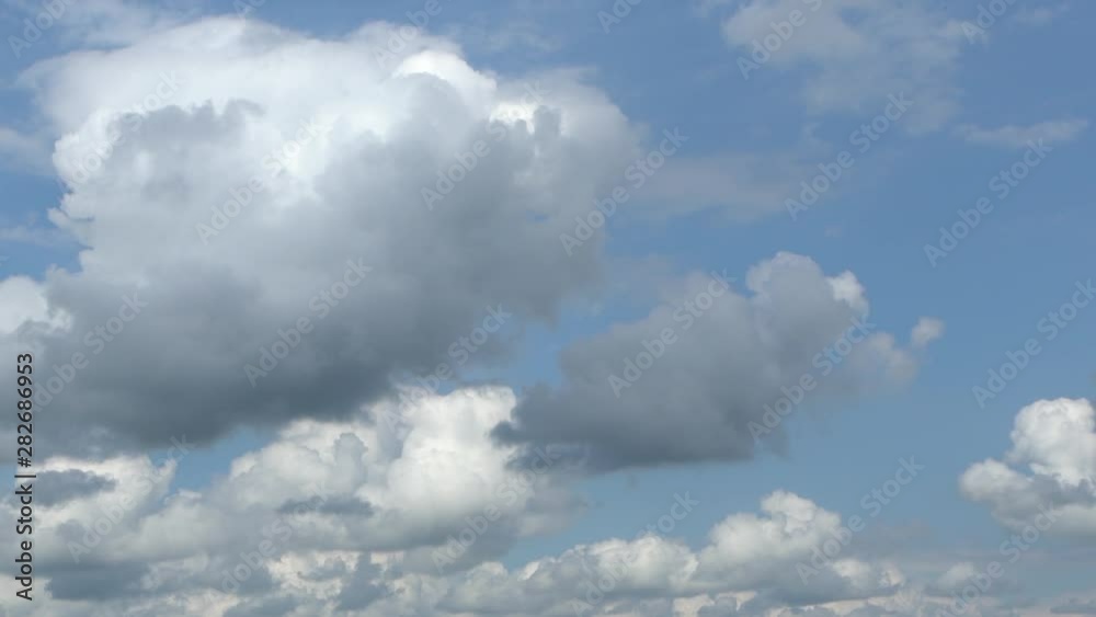 Fluffy white clouds moving along clear blue sky than transforming into grey rainy clouds. Beautiful skyscape timelapse natural video background. Fluffy white clouds moving along clear blue sky than transforming into grey rainy clouds. Beautiful skyscape timelapse natural video background.