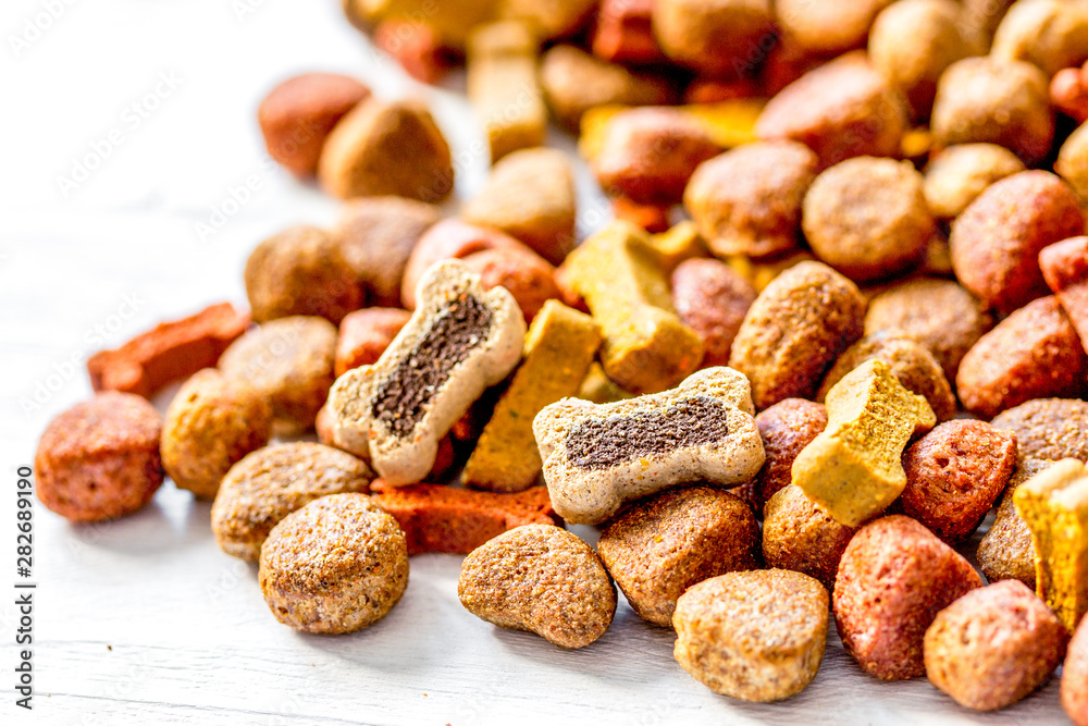 dry dog food in bulk on wooden background close up Stock Photo | Adobe Stock