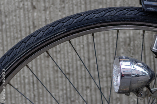 Photography Schwarzer Fahrradreifen mit silbernem Halogenstrahler als Fahrradlampe und Dynam