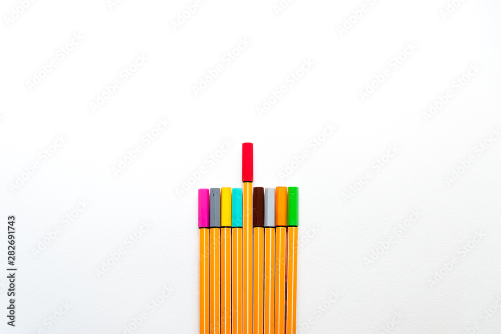 colourful markers as a symbol of difference and creativity between individuals with one red marker marker higher than others colourful markers as a symbol of difference and creativity between individuals with one red marker marker higher than others
