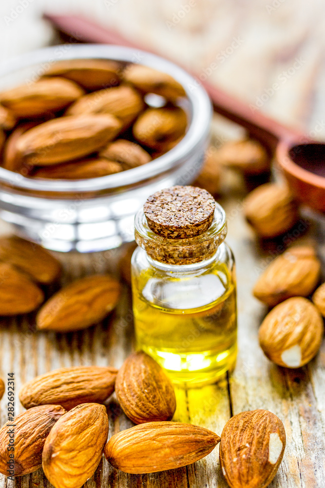 spa with almond oil in organic cosmetic set on wooden background spa with almond oil in organic cosmetic set on wooden background