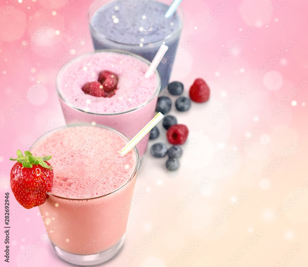Three Fruit Smoothies with Straws Isolated on a White Background Three Fruit Smoothies with Straws Isolated on a White Background