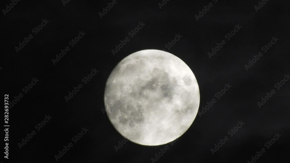 Moon With Clouds In The Night Sky. Concept of a spooky theme and mystery. Mysterious night sky with moon and dramatic clouds passing. Dark night with moon. Moon With Clouds In The Night Sky. Concept of a spooky theme and mystery. Mysterious night sky with moon and dramatic clouds passing. Dark night with moon.