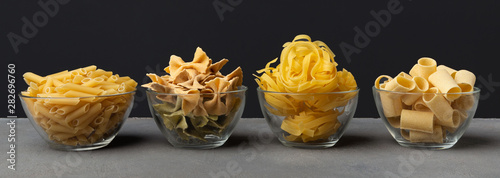 Different shape pasta with carbohydrates on black background