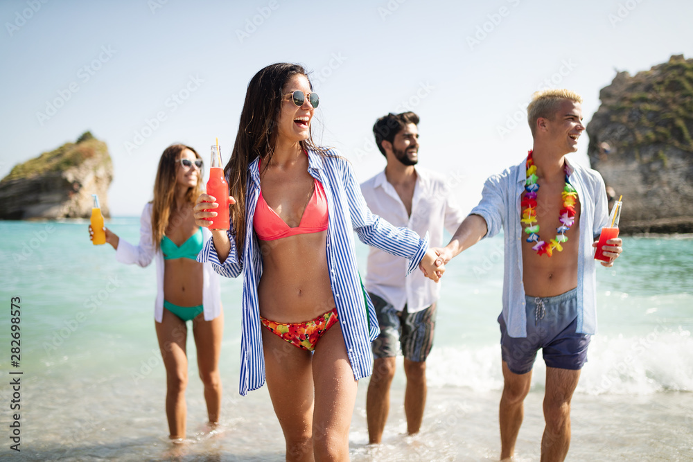 Group of happy friends enjoying the beach at summer Group of happy friends enjoying the beach at summer
